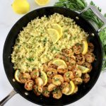 overhead view of Shrimp Scampi with Cauliflower Rice in skillet with lemon slices