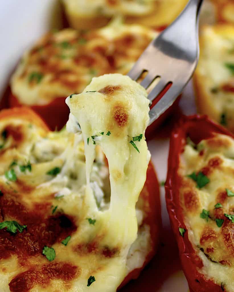 fork pulling cheese out of stuffed pepper