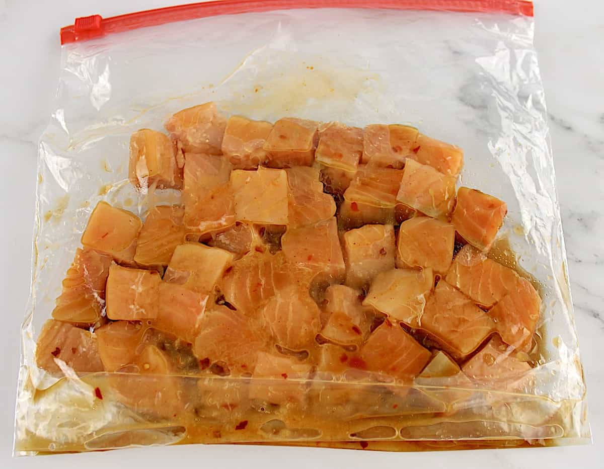 Air Fryer Salmon Bites uncooked in food storage bag marinating