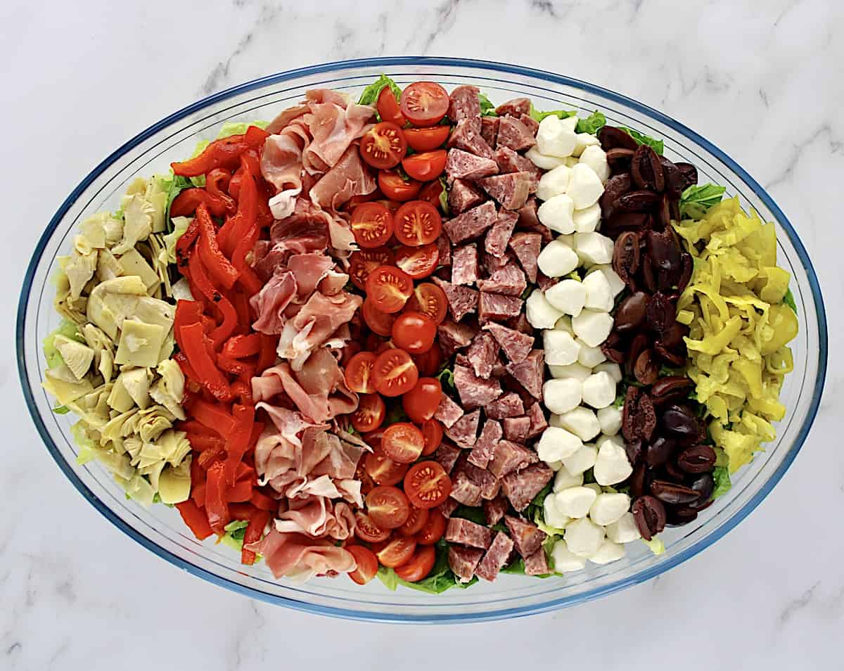 Antipasto Salad with ingredients arranged in rows in oval bowl
