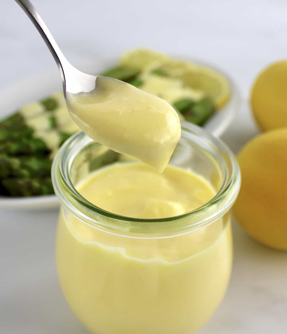 Hollandaise Sauce being spooned out of glass jar