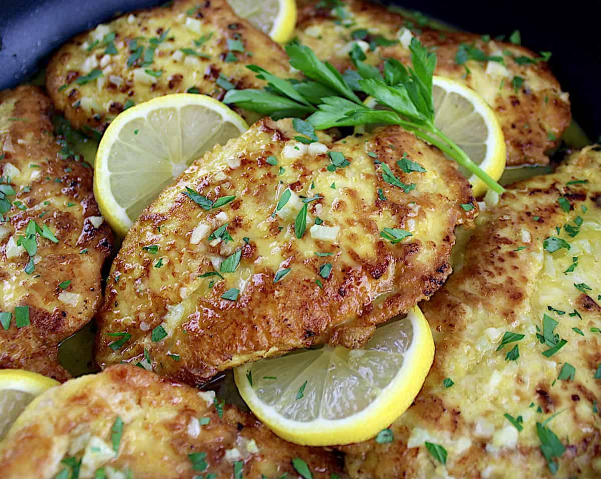 closeup of Keto Chicken Francese with parsley and lemon slices