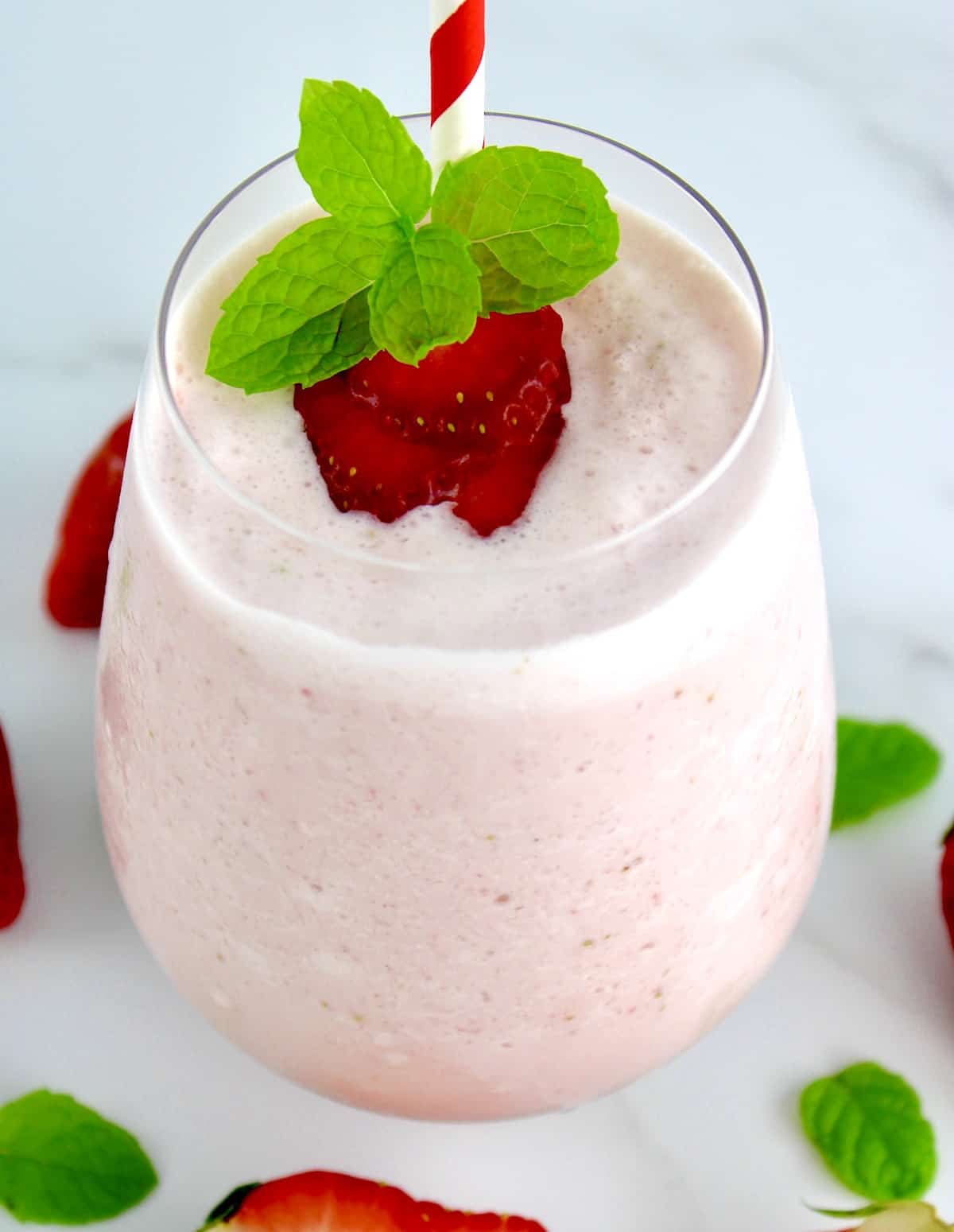 overhead view of Keto Strawberry Cheesecake Smoothie with strawberry slices and mint