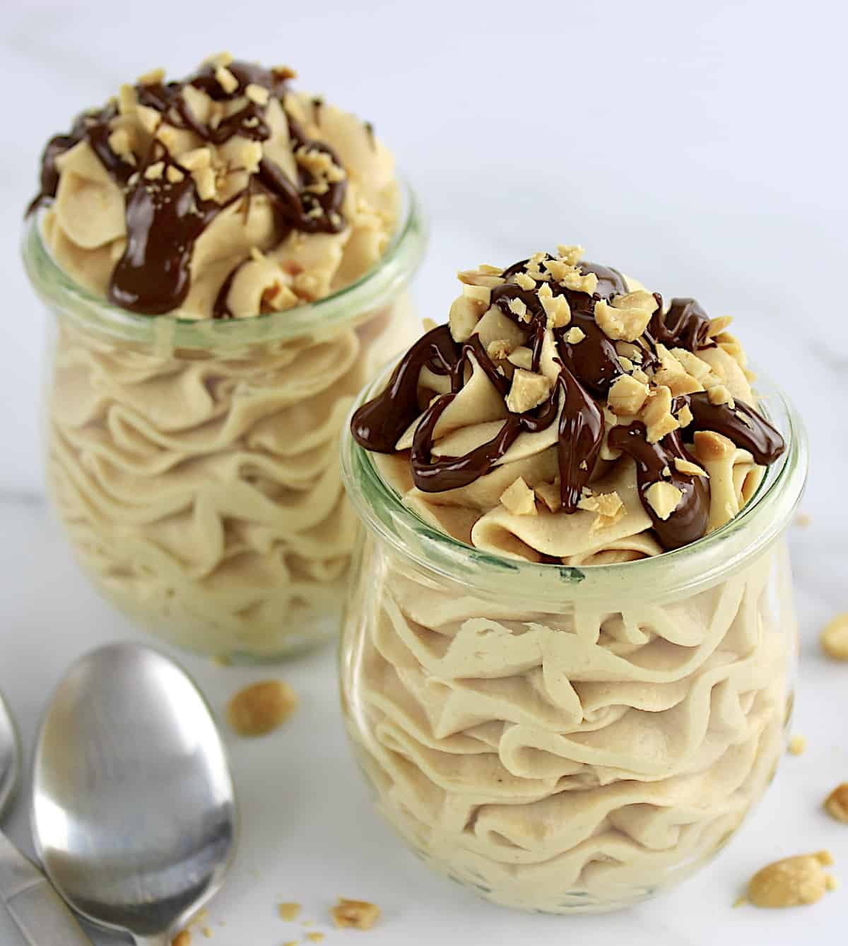 2 jars of Peanut Butter Mousse with melted chocolate and chopped peanuts on top