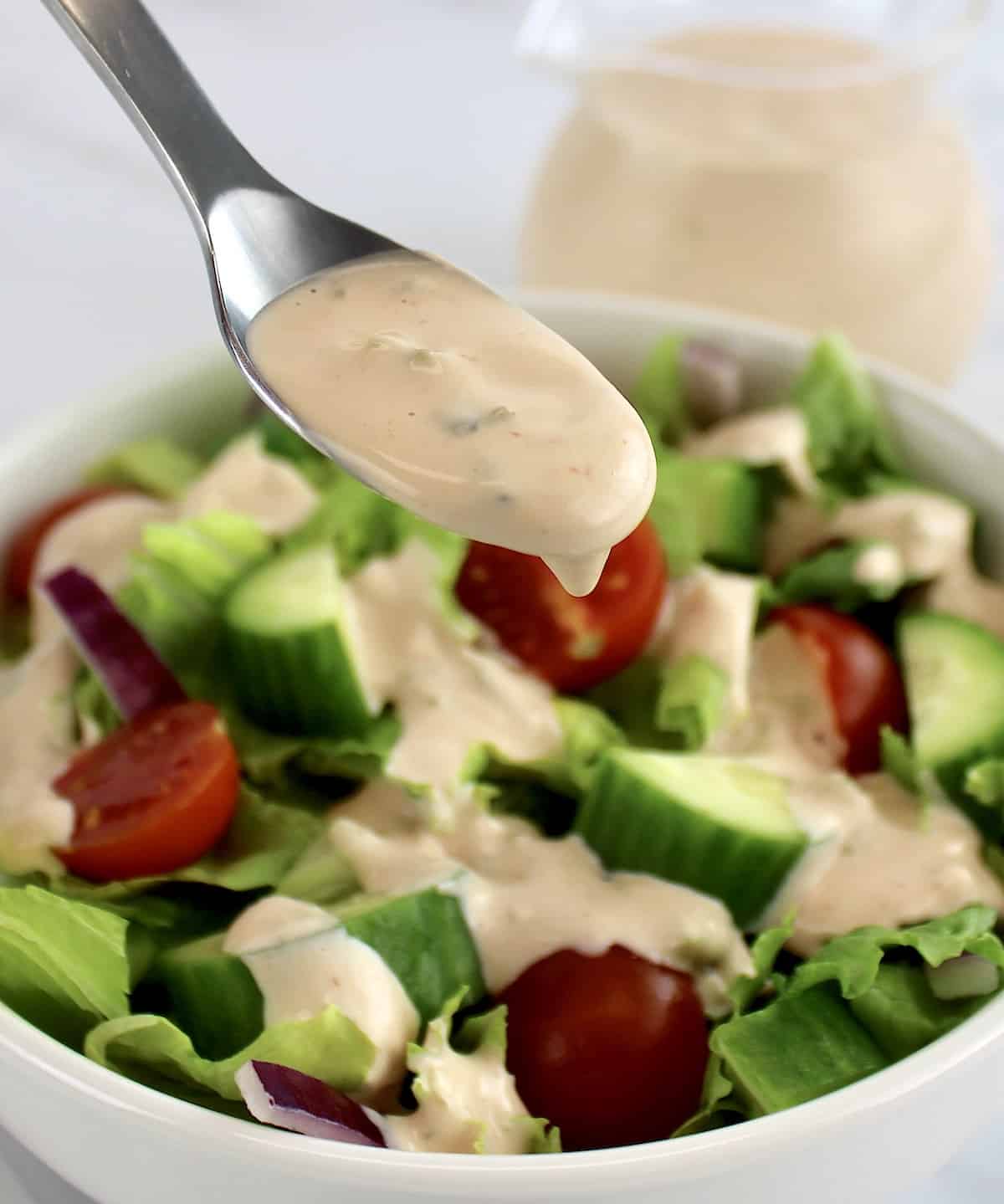 Thousand Island Dressing being spooned over salad