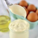 Easy Homemade Keto Mayonnaise being spooned out of open glass jar