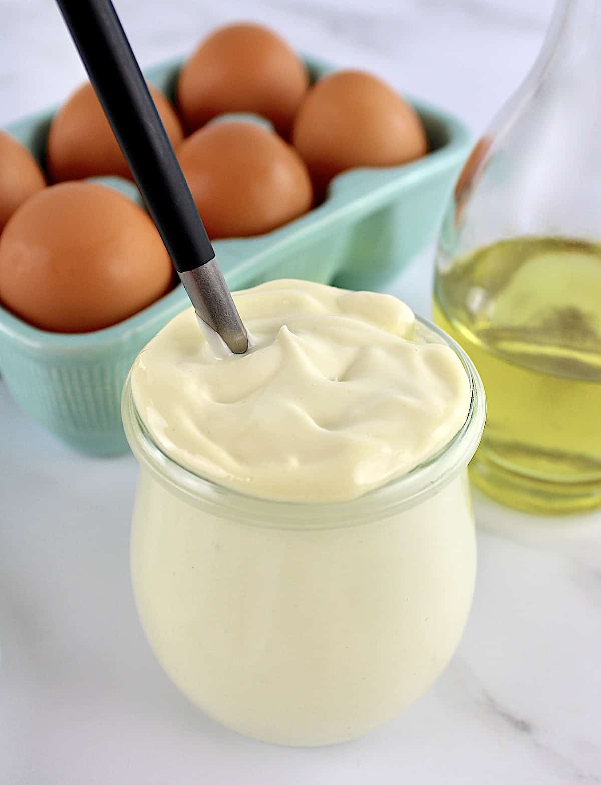 Easy Homemade Keto Mayonnaise in glass jar with knife in it