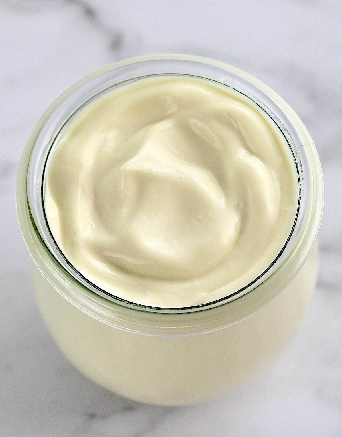 overhead view of Easy Homemade Keto Mayonnaise in open glass jar
