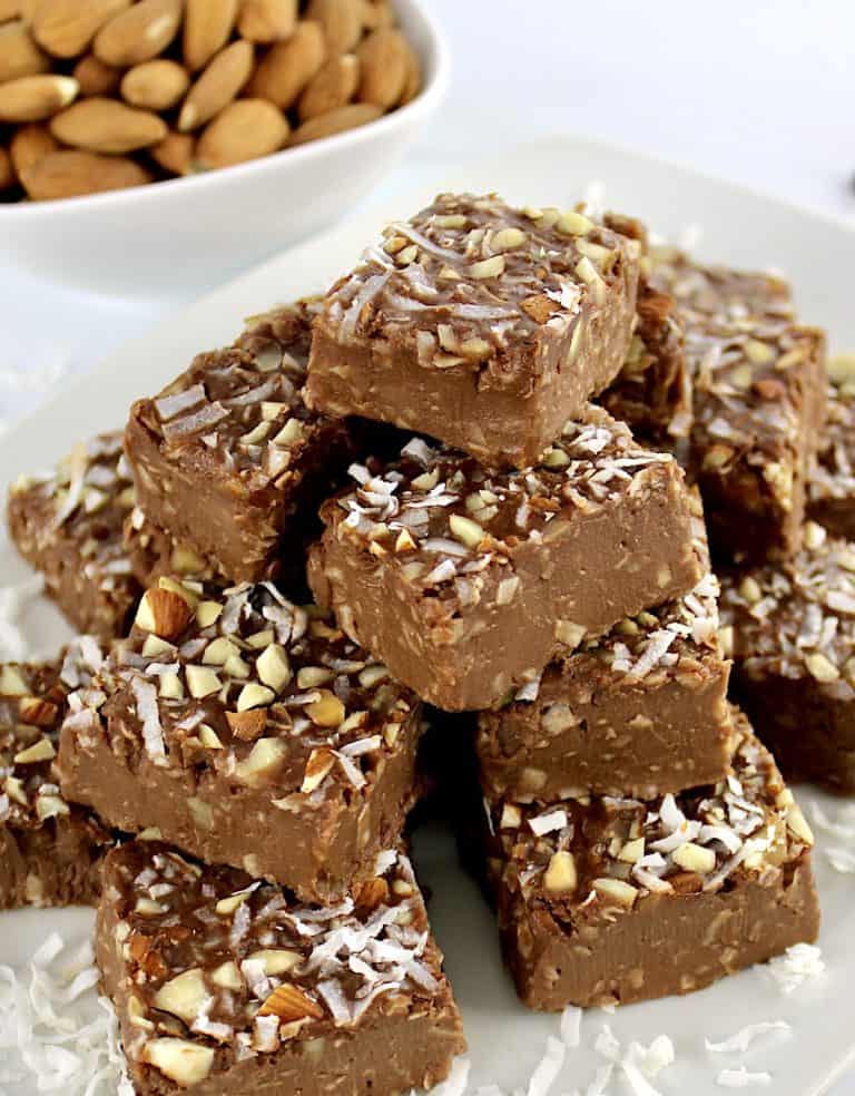 Keto Almond Joy Fudge pieces stacked up on white plate