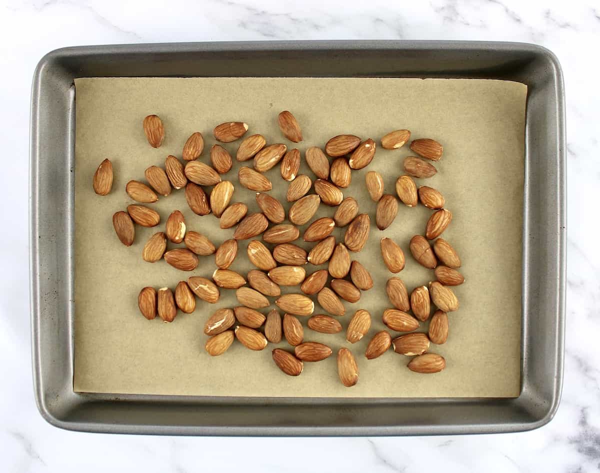 whole almonds on parchment lined baking sheet