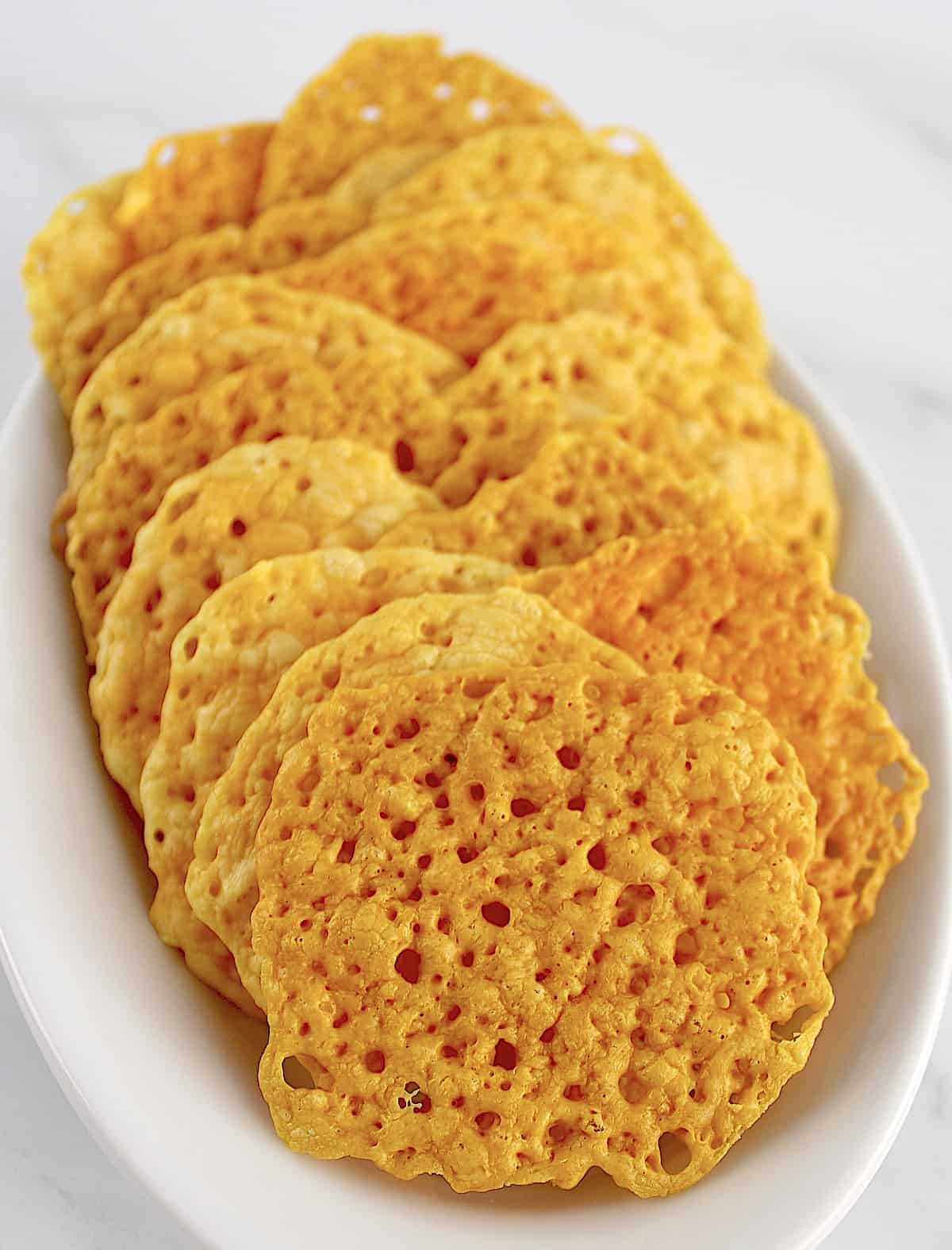 Keto Baked Cheese Crisp Crackers in white dish