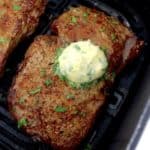 Air Fryer Steak with butter on top in air fryer basket