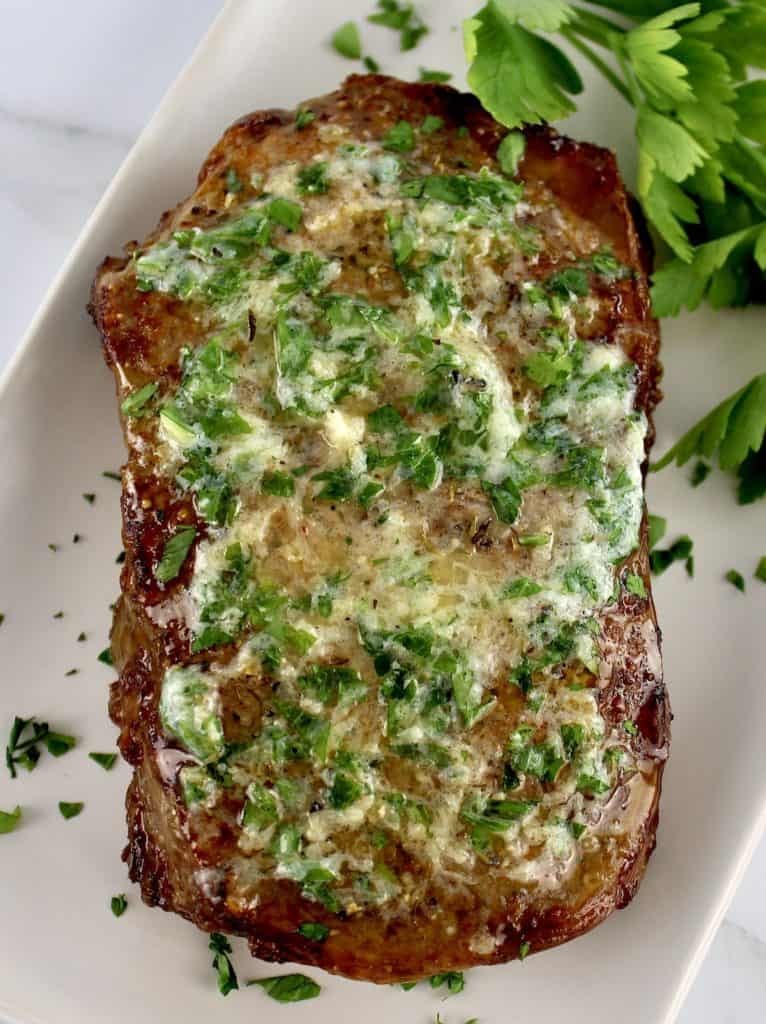 Air Fryer Steak with parsley butter spread on top