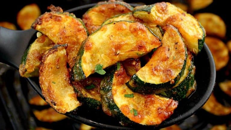closeup of Air Fryer Zucchini in black serving spoon