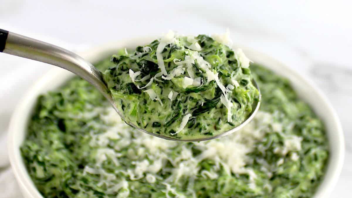 Creamed Spinach with cheese on top in spoon