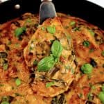 Creamy Tuscan Chicken Skillet with silver spatula in skillet