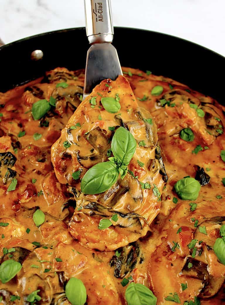 Creamy Tuscan Chicken Skillet with silver spatula in skillet