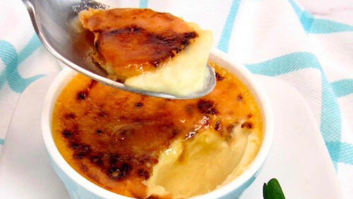 creme brulee in spoon held up over ramekin