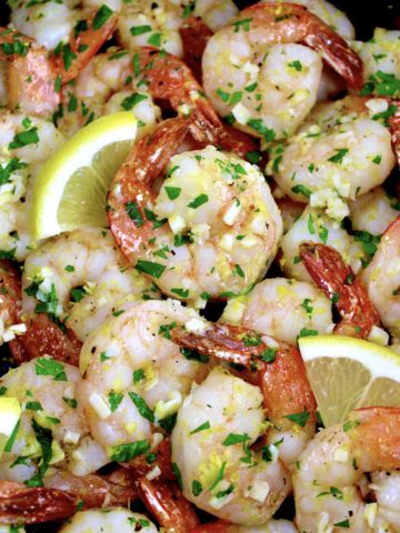 closeup of Air Fryer Shrimp Scampi with lemon slices and chopped parsley