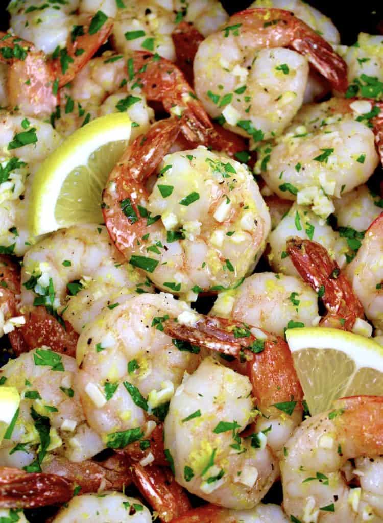 closeup of Air Fryer Shrimp Scampi with lemon slices and chopped parsley