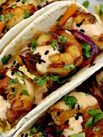 Asian Shrimp Tacos with sauce drizzled over top