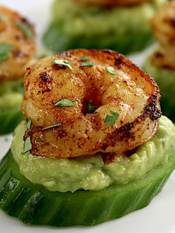 Avocado Shrimp Bites on white plate with chopped parsley