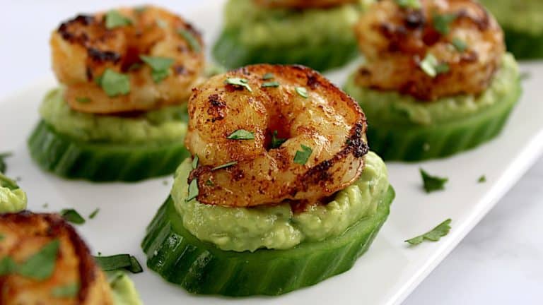 Avocado Shrimp Bites on white plate with chopped parsley