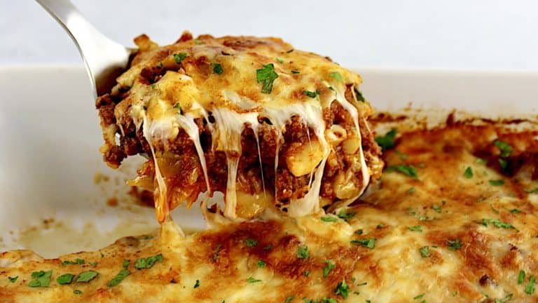 Cabbage Roll Casserole being lifted out of casserole with cheese pulling