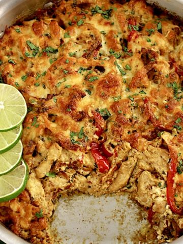 overhead view of Chicken Fajita Casserole in skillet with lime slices