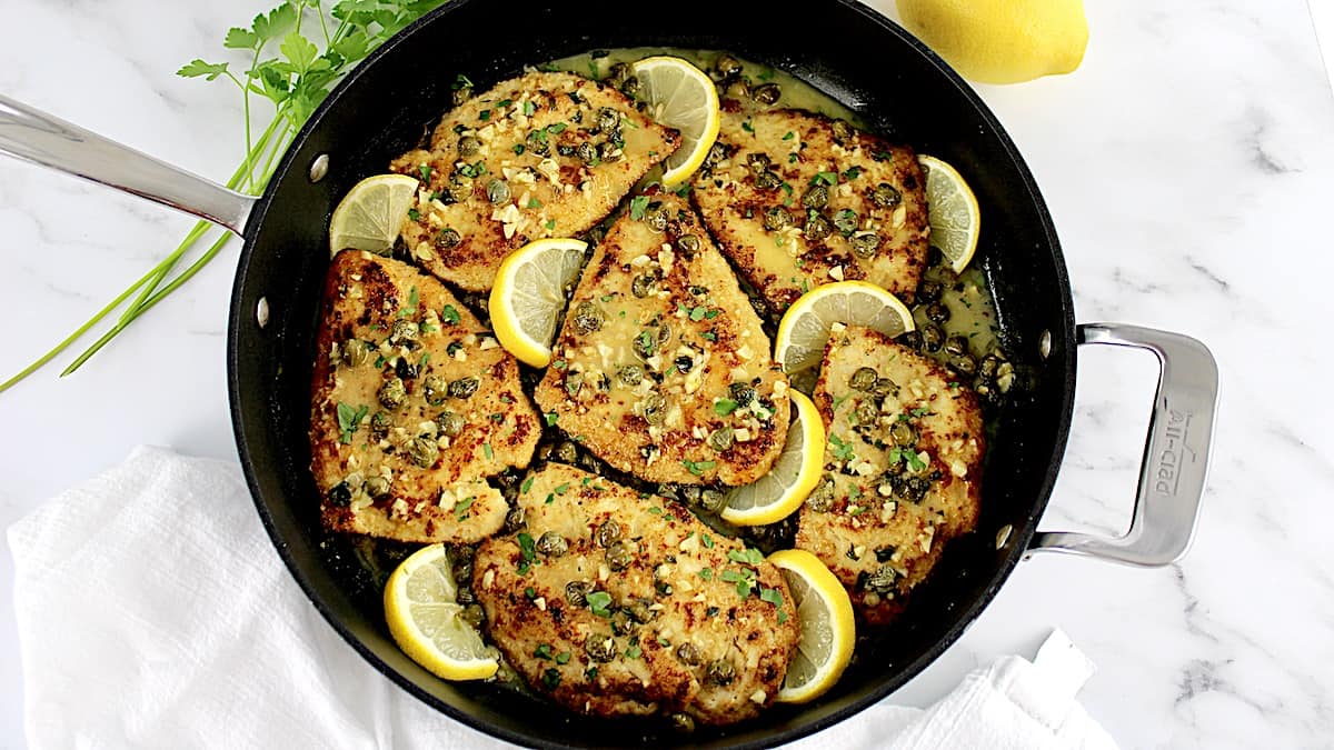 overhead view of Chicken Piccata in skillet with lemon slices