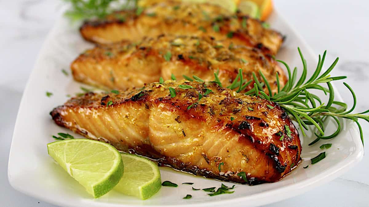 Citrus Glazed Salmon on white plate with lime slices