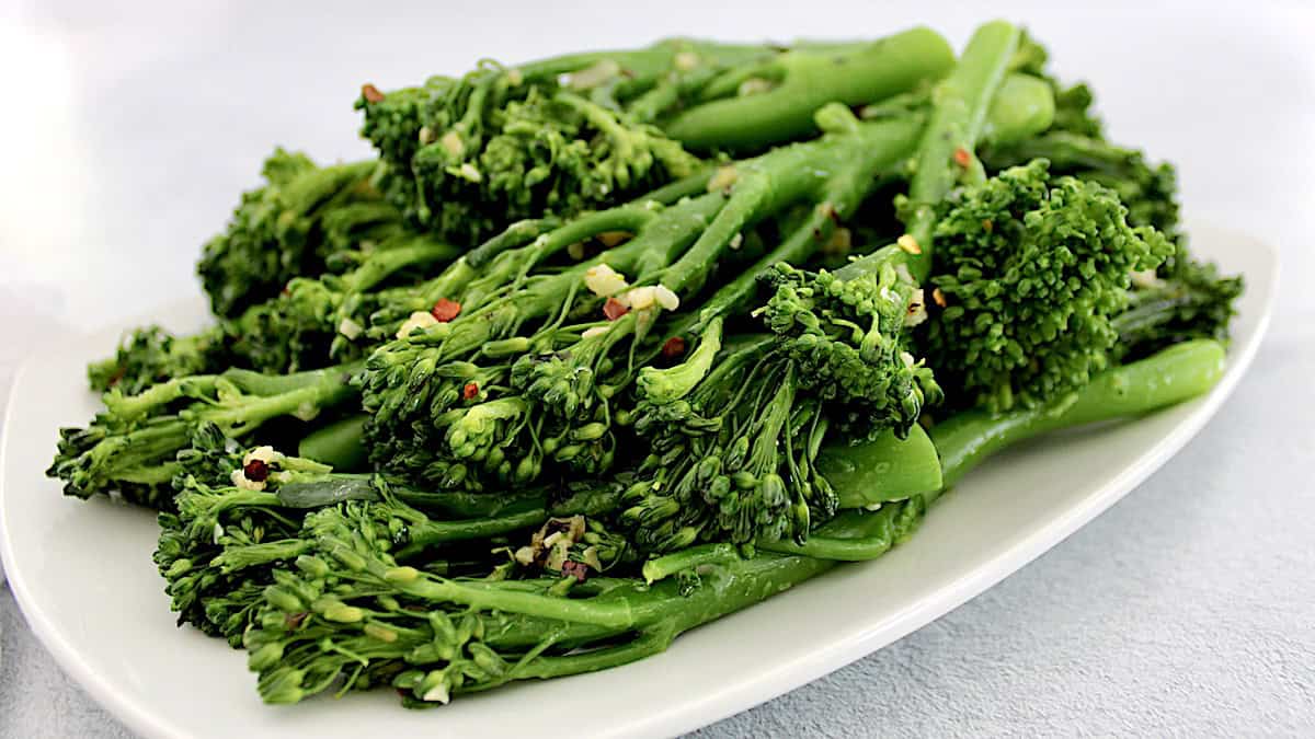 sauteed broccolini with garlic on white plate