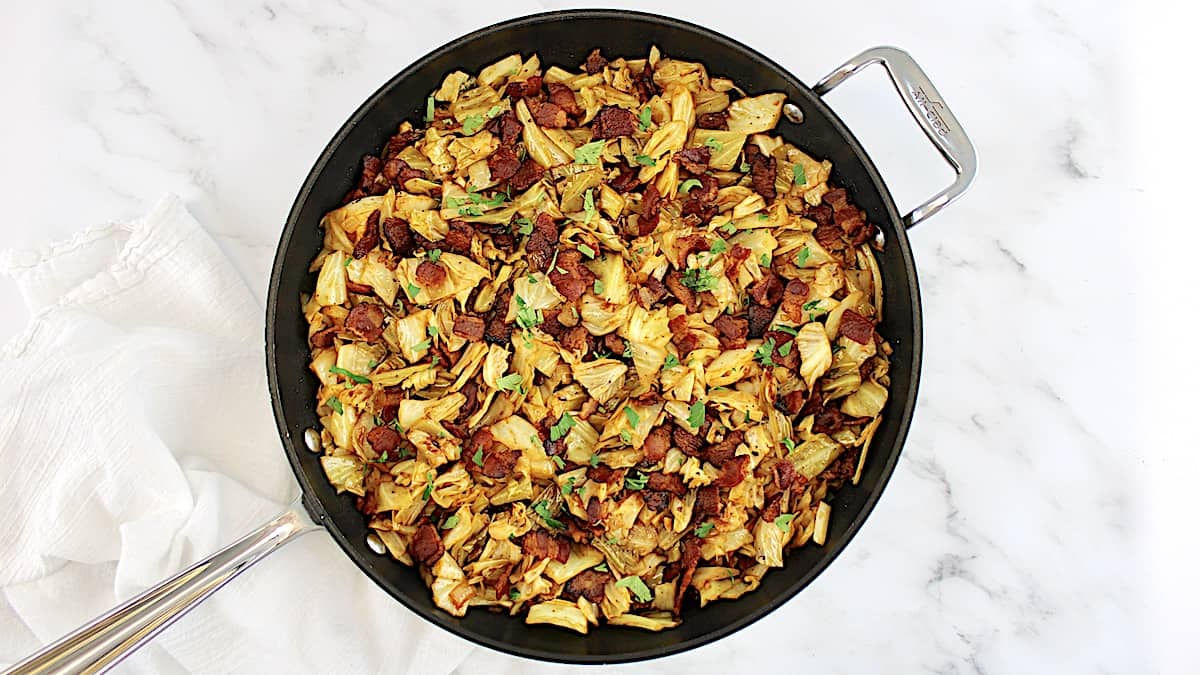 Fried Cabbage with bacon in skillet