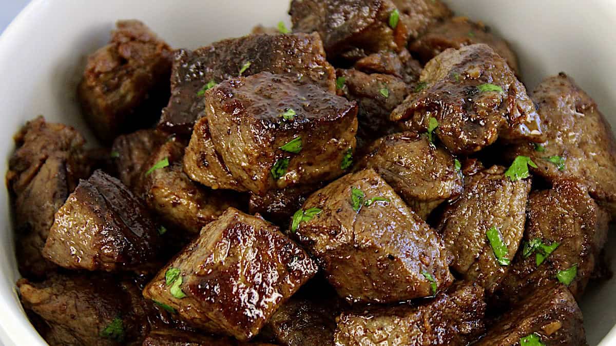 closeup of Garlic Butter Steak Bites with chopped parsley