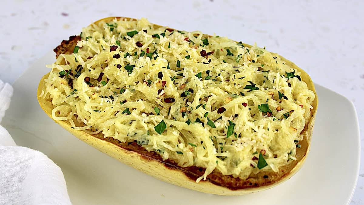 Garlic Parmesan Spaghetti Squash in spaghetti squash half with chopped parsley