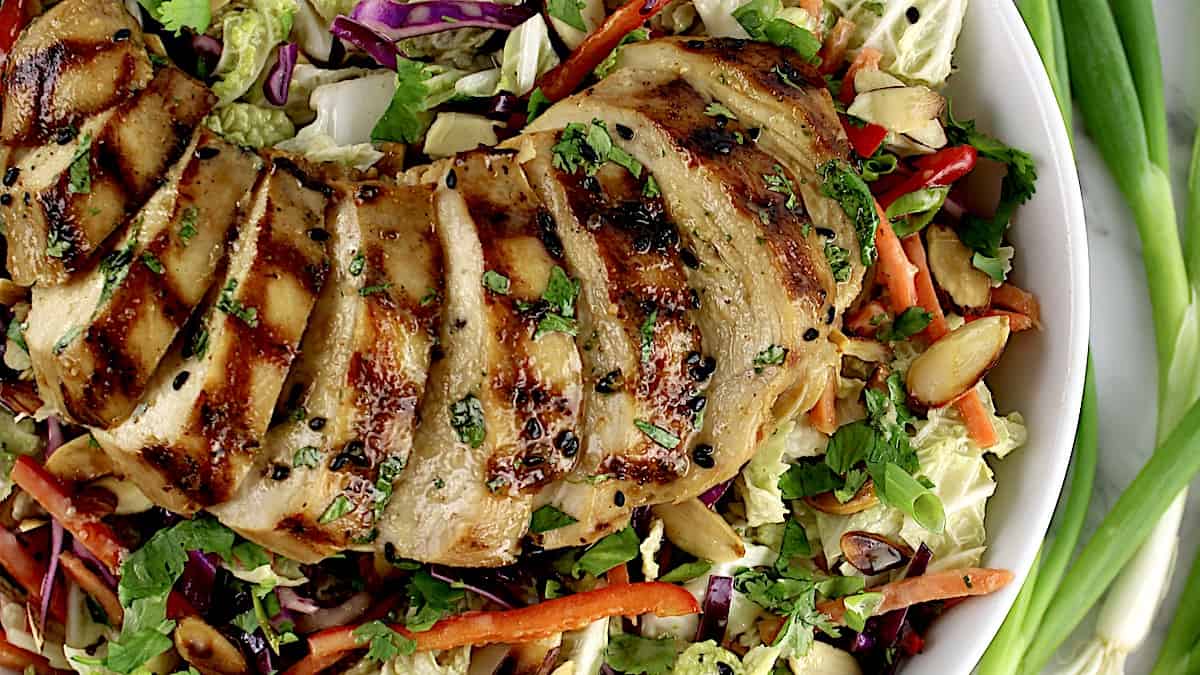 Grilled Asian Chicken Salad with sliced chicken on top
