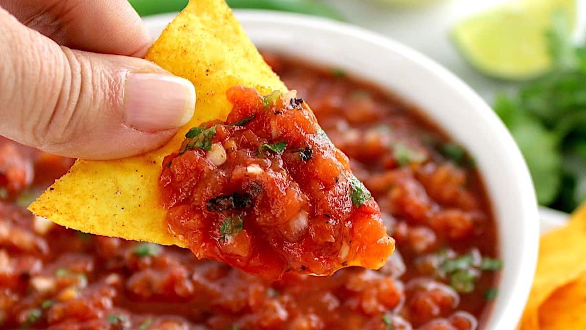 easy homemade salsa scooped up with chip