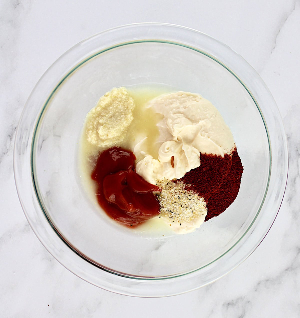 zesty dipping sauce ingredients in glass bowl unmixed