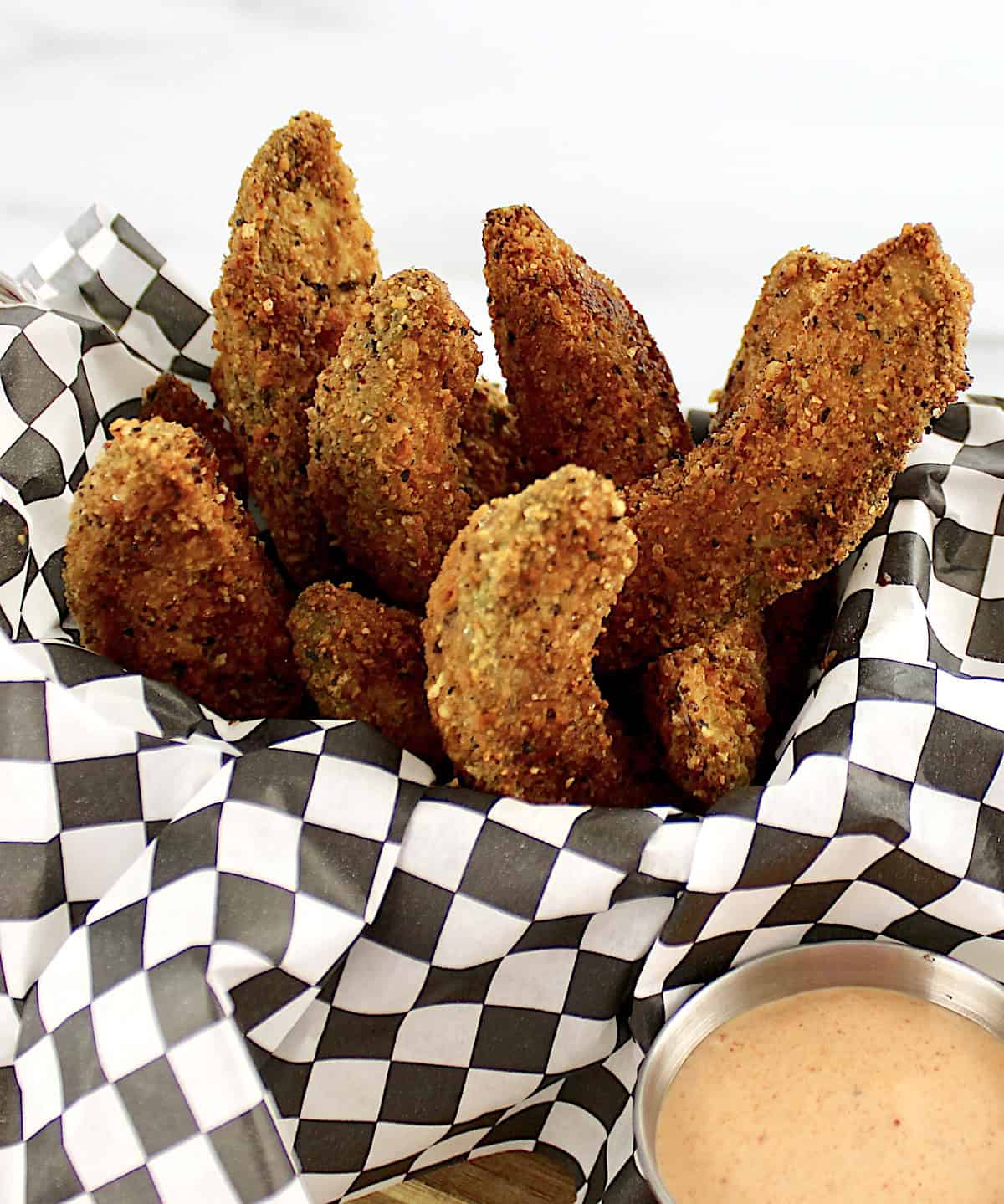 avocado fries standing up in black and white checkered paper