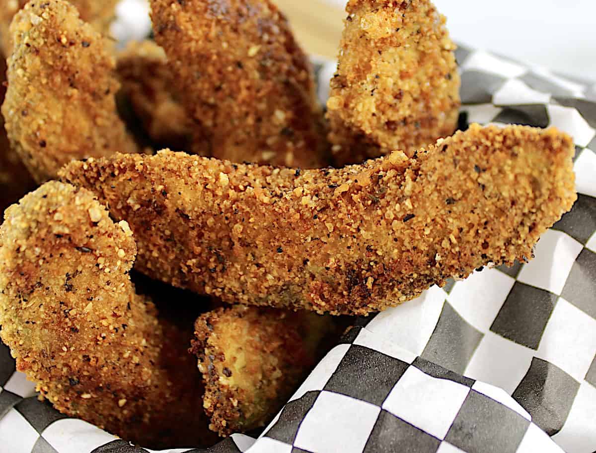 closeup of avocado fries in black and white checkered paper