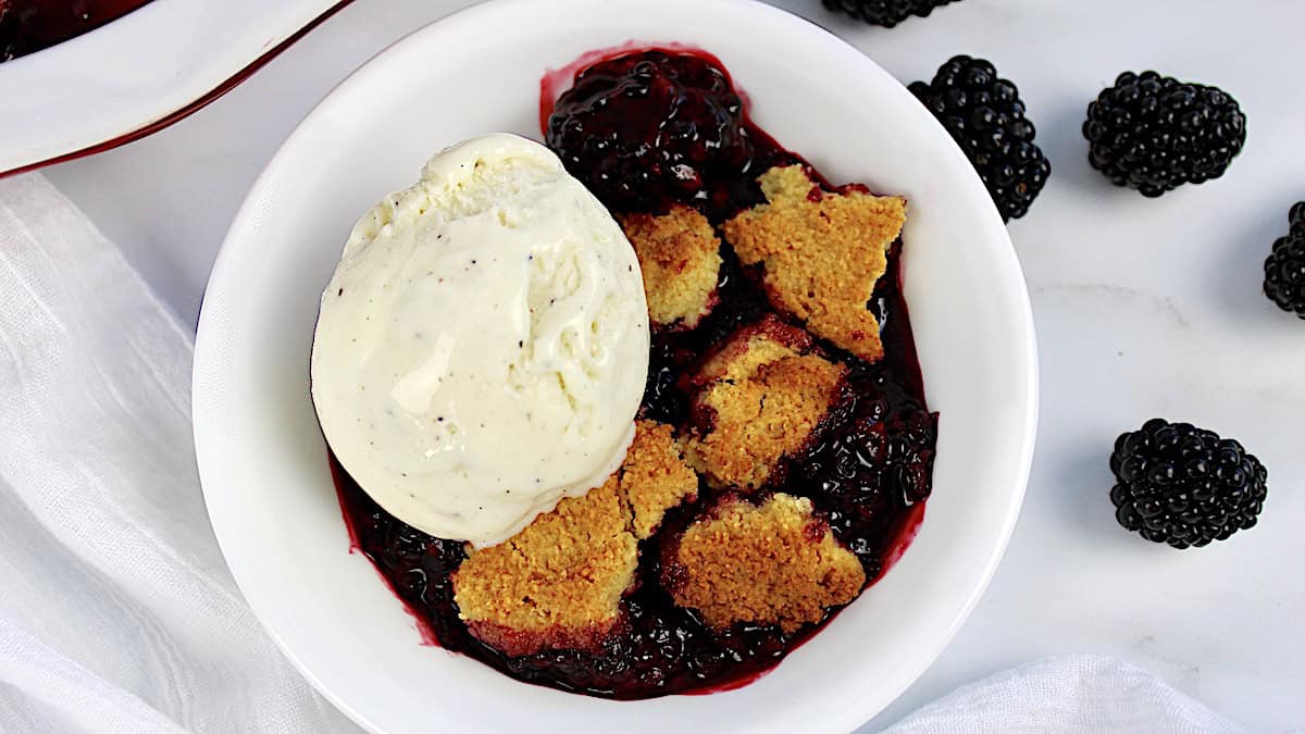 Keto Blackberry Cobbler with scoop of vanilla ice cream on top