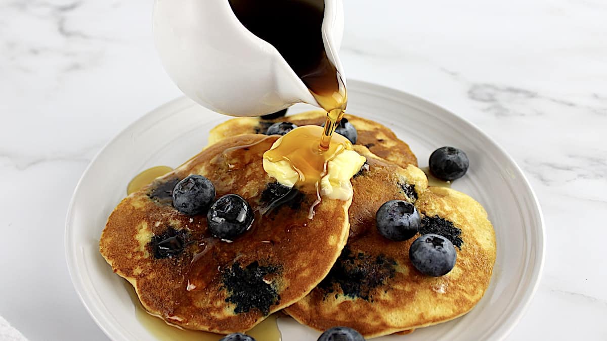 Keto Blueberry Pancakes with syrup being poured over top