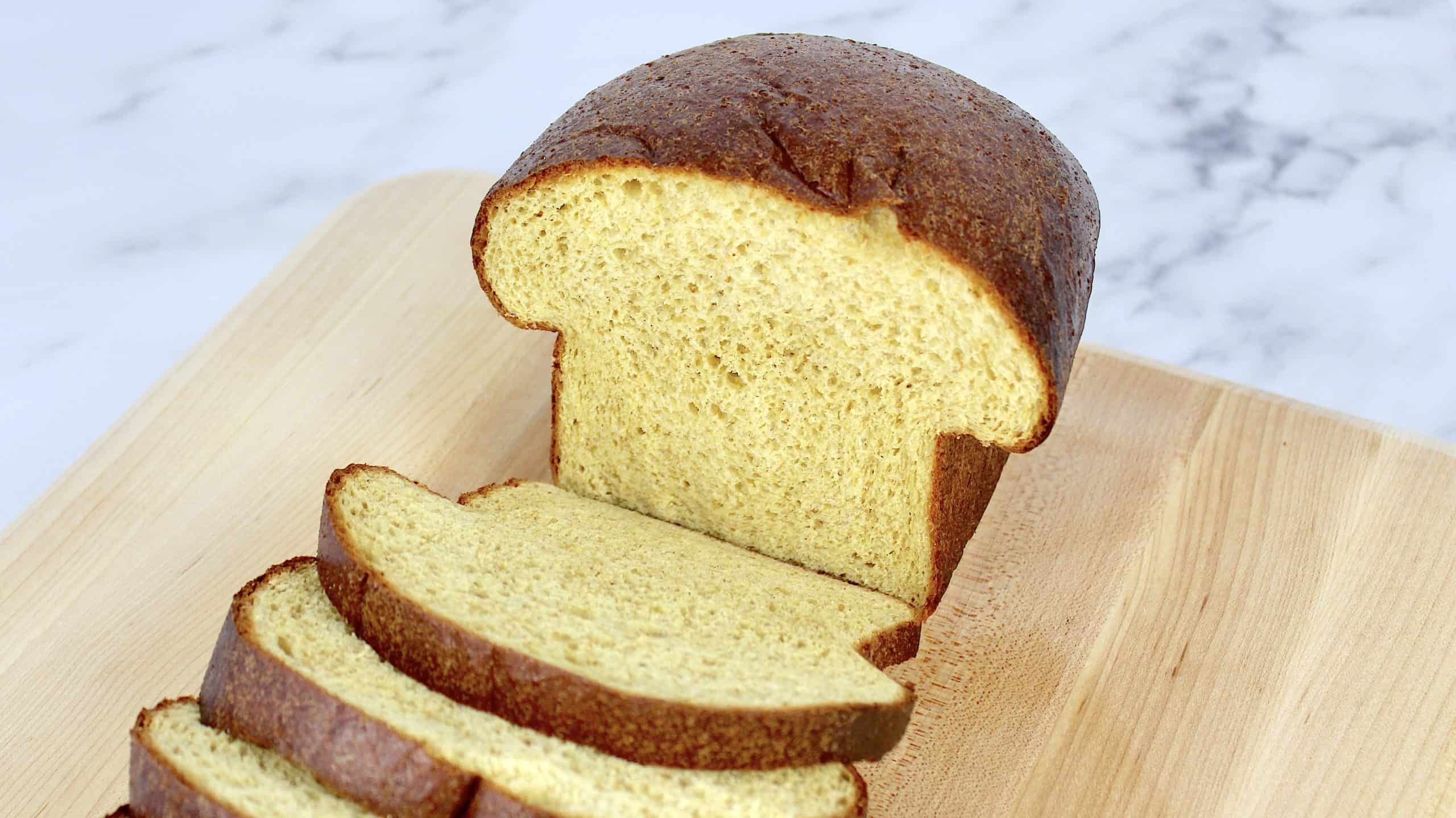 Homemade Keto Bread cut open on cutting board with slices