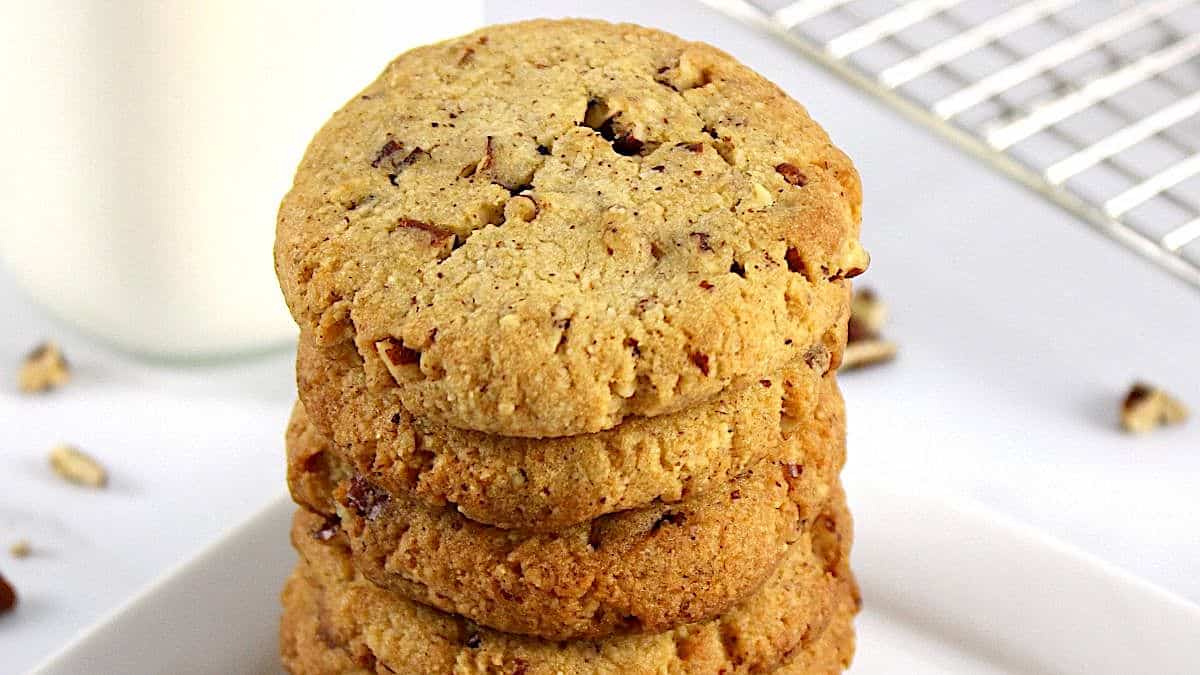 keto butter pecan cookies stacked up on white plate