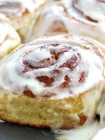 Keto Cinnamon Rolls in baking pan with icing on top