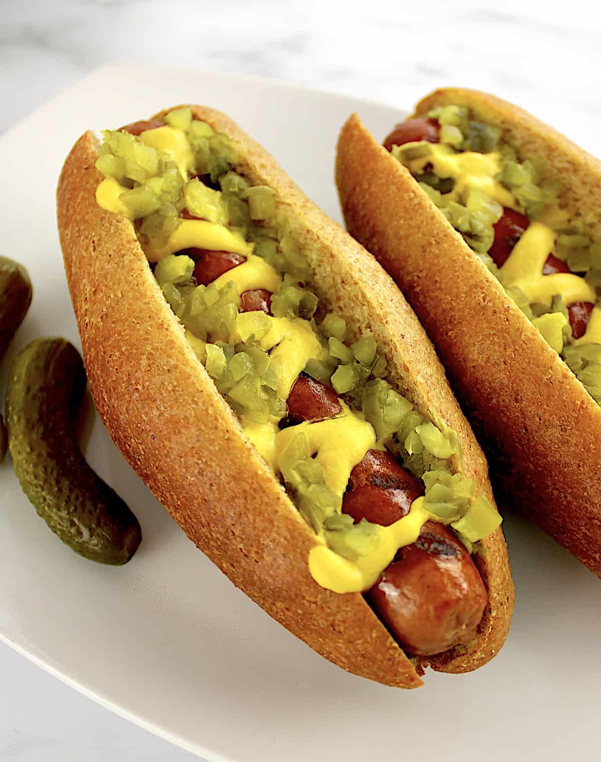closeup of Keto Hot Dog Bun with hot dog, mustard and relish on top