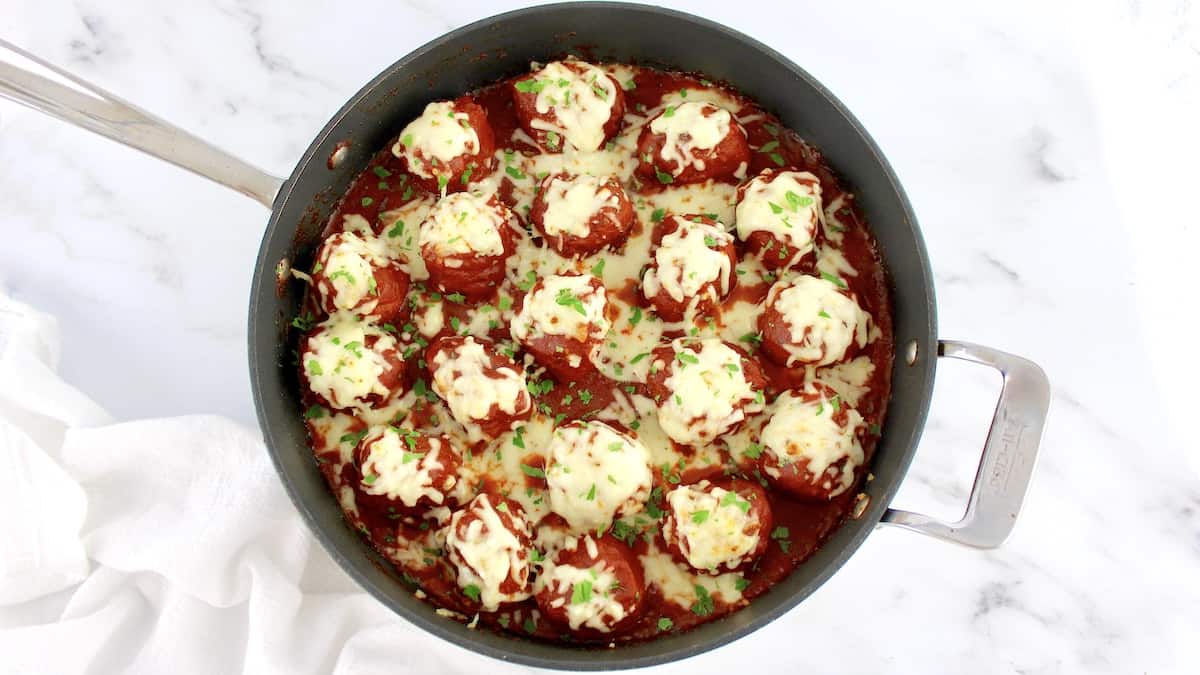 Keto Italian Meatballs in skillet with melted mozzarella cheese on top