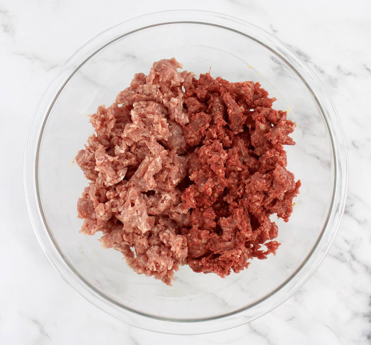 ground beef and pork in mixing bowl