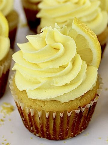 Keto Lemon Cupcakes on white plate with lemon slice on top