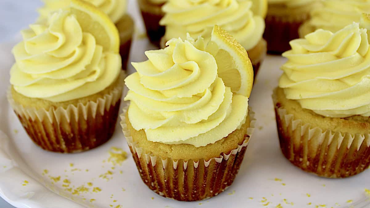 Keto Lemon Cupcakes on white plate with lemon slice on top